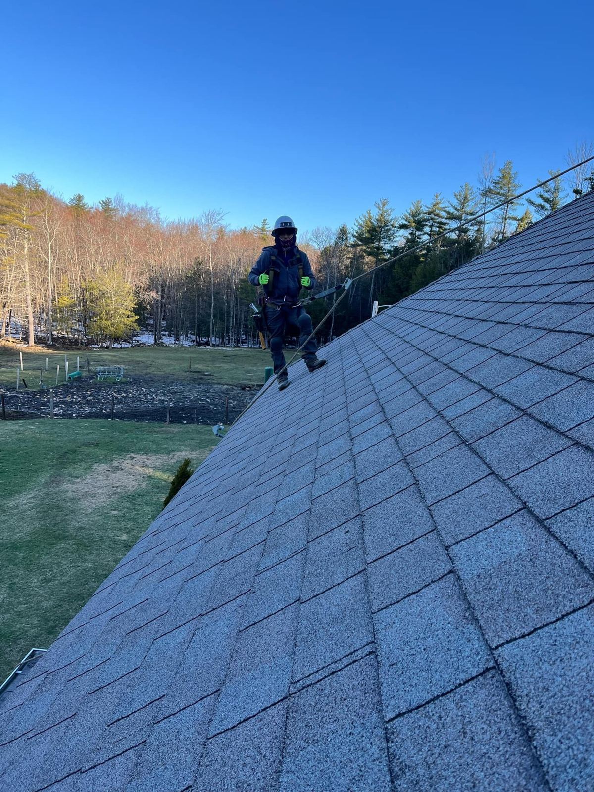 Nando General Construction crew working on a shingle roof