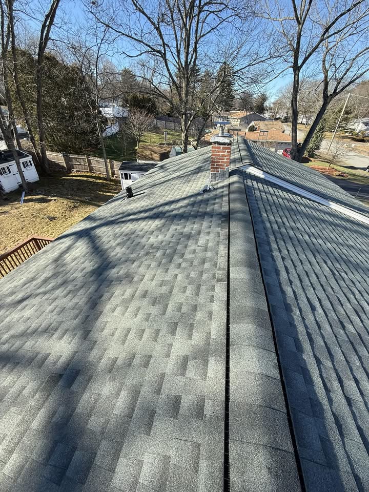 New shingle roof with ridge vent and chimney flashing
